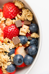 Healthy muesli or cereal breakfast bowl with granola made of toasted rolled oats, organic honey,...