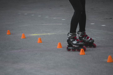 man skates on asphalt and goes round cones