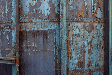 Creative industrial background with rusty metal, rivets, and peeling paint patinas, horizontal aspect