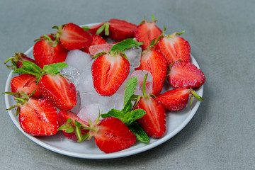 Strawberry fresh, red, juicy with ice decorated with mint. Diet food for a beautiful figure.