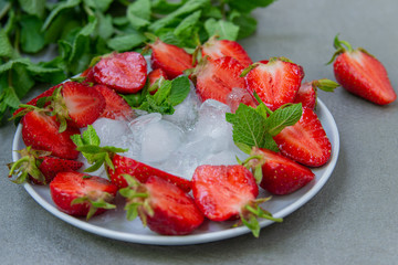 Strawberry fresh, red, juicy with ice decorated with mint. Diet food for a beautiful figure.
