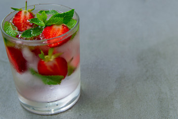 Cooling drink with strawberries ,ice and mint.  It is very refreshing and gives strength on a hot summer day. copy space