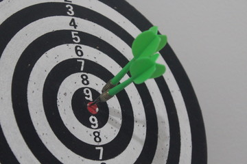 dart game with hit on target, green and red darts. Competition in the business world.