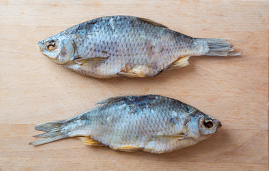 Dried fish on the table. Salty dry river fish on a wooden background