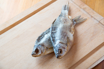 Dried fish on the table. Salty dry river fish on a wooden background