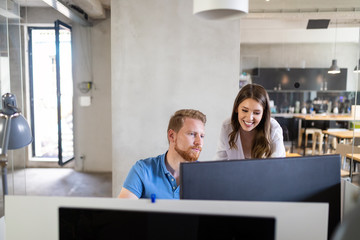 Programmers cooperating at IT company developing apps