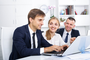 Three active coworkers working in company office