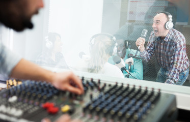 Fototapeta na wymiar Man singing in radio studio