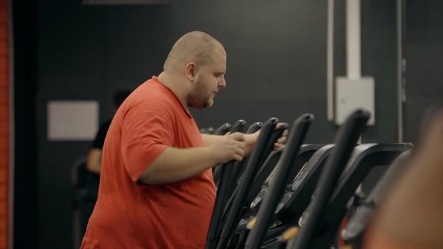 Man making warm up training on orbitrek