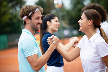 Group of tennis player handshaking after playing a tennis match. Fairplay, sport concept.