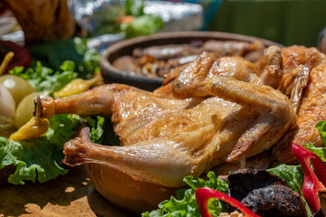 Traditional georgian food grilled chicken Tabaca with fresh vegetables