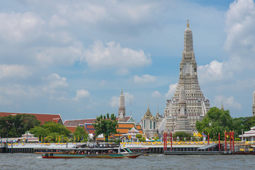 Wat Arun Temple located in Bangkok Thailand near River with the blue sky