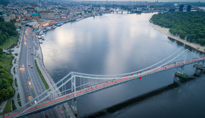 Aerial night view of the city of Kiev near the pedestrian bridge.