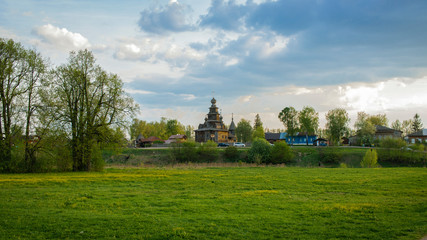 Orthodox Church on a hill, green grass and sky