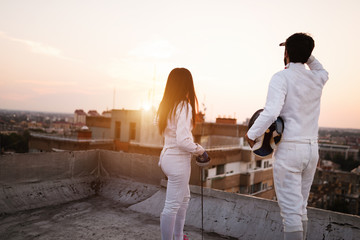 Fencing athletes people practicing outdoor on rooftop