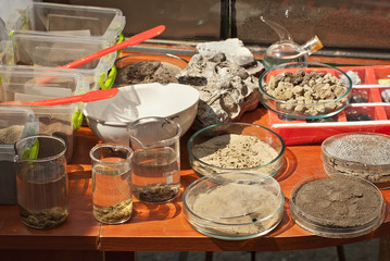 Soil experiments at the scientific fair. Test tubes with soil samples. An overview of the blurring of rocks by groundwaters.