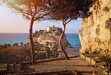 beautiful italian town Tropea, in south of Italy with the iconic beach, old town and church at the cliff. Sunset