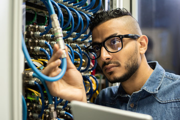 Technical engineer examining mainframe computer