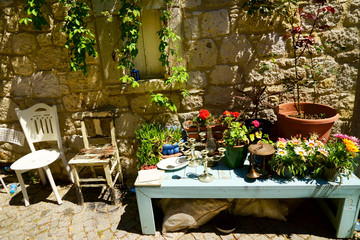 close up stone garden wall with colorful flowers in Alacati town of izmir, Turkey