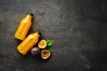 Passion fruits juice and fruits on a wooden background. Tropical Fruits.