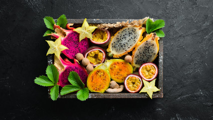 Tropical Fruits - Cactus and dragon fruit on a wooden background. Top view. Free space for text.