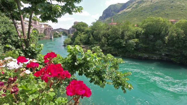 View from the riverside to the old bridge in Mostar and the river Neretva