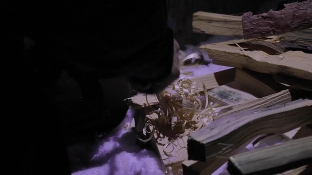 Preparing the wood to be placed in the fire pit. Flat plane. High angle shot