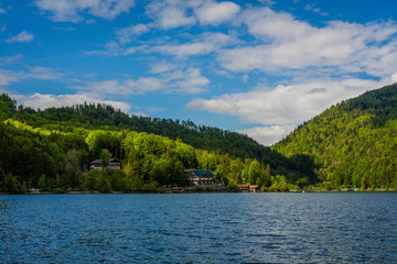 view to lonely houses in the hills, mountains from lakeside