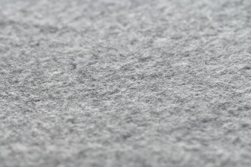 Warm and cozy gray wool blanket texture, wool fabric in grey close-up textured.