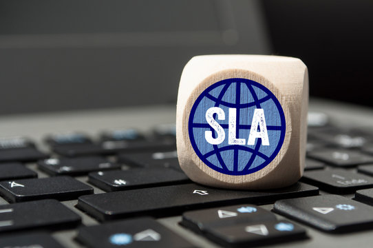 Cube on laptop keyboard with SLA Service-Level-Agreement