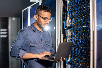 Arabian server engineer using laptop
