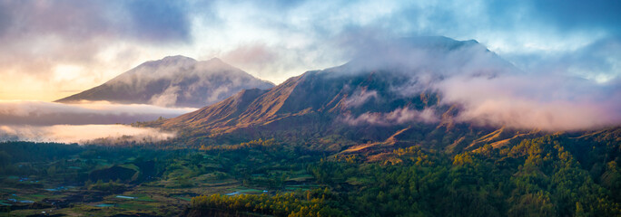 Bali, Indonesia. Batur volcano with caldera and Agung volcano in the morning mists.