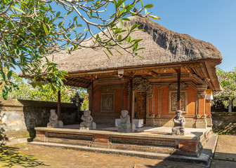 Ubud, Bali, Indonesia - February 26, 2019: Batuan Temple. Large closed shrine with reed roof set on...