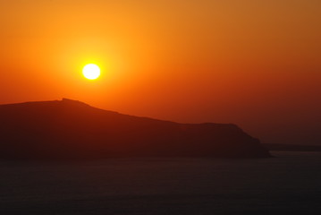 The volcano of Fira at Sunset as seen from the Santorini Island