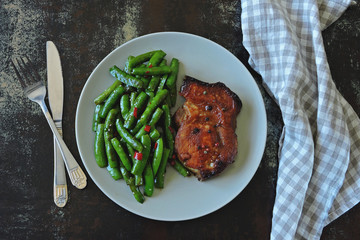 Pork steak and string beans. Keto diet. Paleo diet. Pegan Diet.