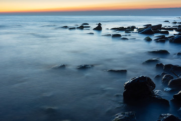 Fototapeta na wymiar Rocky sea beach after sunset, Black Sea, Anapa, Russia
