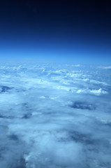 aerial view from plane, blue sky with clouds and sun