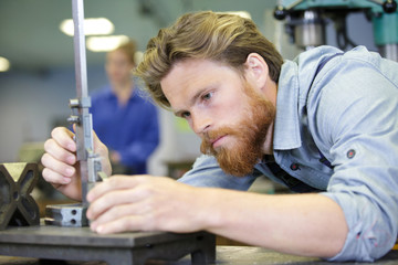 industry worker with cnc machine at factory