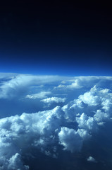 Obraz premium aerial view from plane, blue sky with clouds and sun