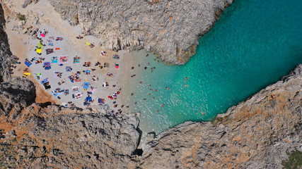 Aerial drone photo of heavenly turquoise rocky beach in shape of fjord of Seitan limania or Agiou Stefanou, Chania - Akrotiri, Crete, Greece