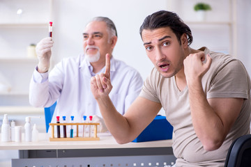 Young handsome man during blood test sampling procedure 