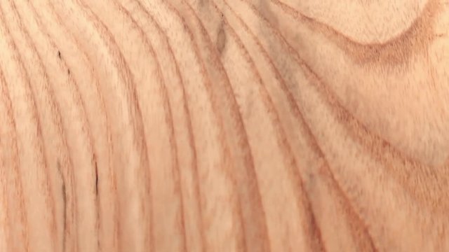 Hypnotizing wooden texture patterns with a damaged spot, close moving shot