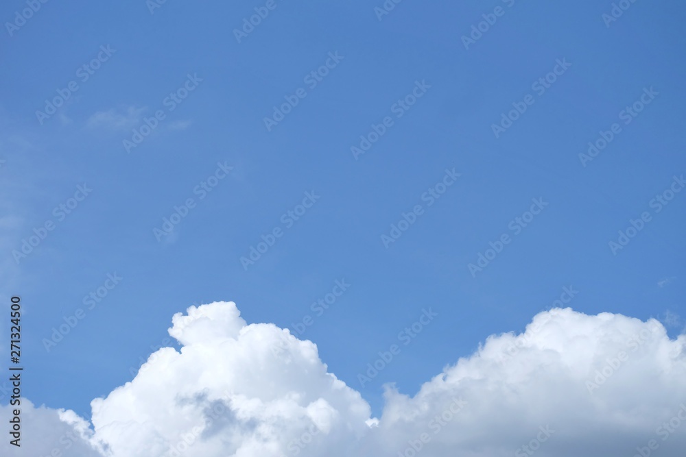 Wall mural blue sky with white fluffy clouds in bright day for background texture