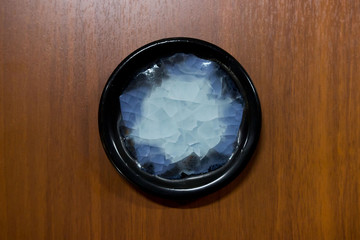 meeting potters. training courses for novice ceramists. reportage. ceramic example of clay saucer with melted colored glass. firing at 1200 degrees Celsius.