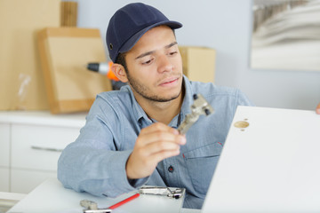 repair technician working with laptop