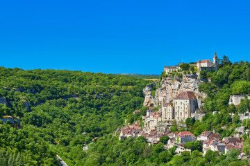 Fototapeta na wymiar Landscape view of the Dordogne tributary river valley cliff with the medieval french village of Rocamadour on one side, Lot Department, Quercy, Occitanie Region, France. UNESCO world heritage site.