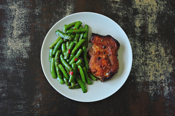 Pork steak and string beans. Keto diet. Paleo diet. Pegan Diet.