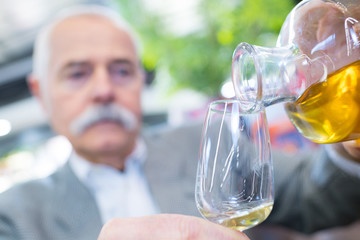 senior man drinking whisky