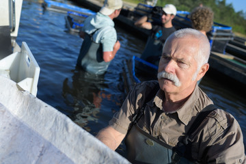 senior man working in a lake