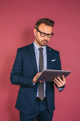 Handsome businessman working in a tablet